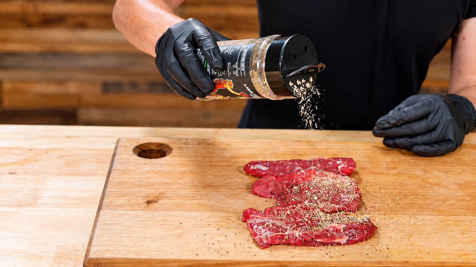This image shows the lamb meat being seasoned. This image shows the lamb meat being seasoned.