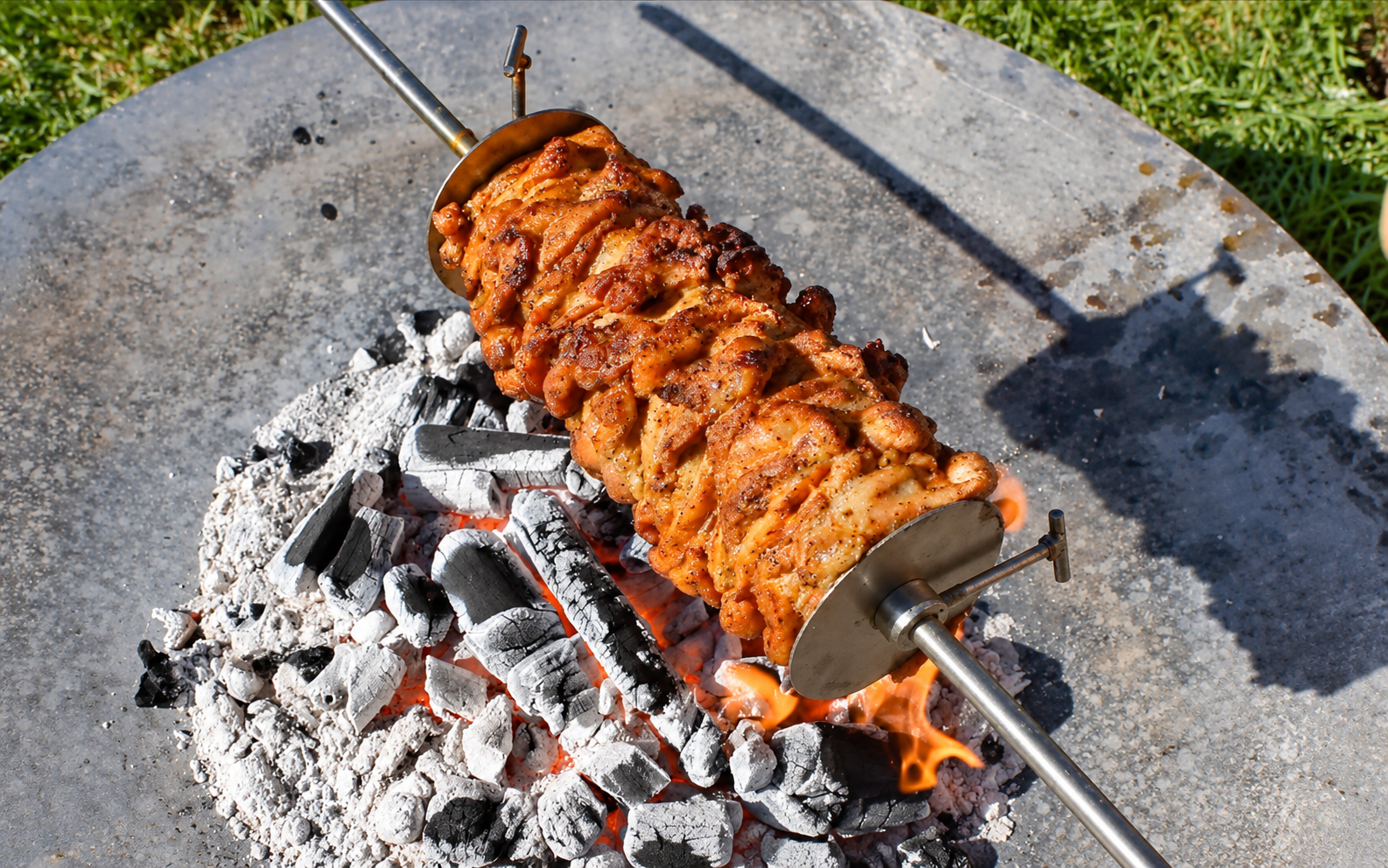 This image shows chicken gyros cooked over charcoal. This image shows chicken gyros cooked over charcoal.