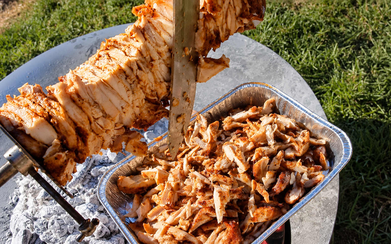 This image shows the chicken gyros being carved. This image shows the chicken gyros being carved.