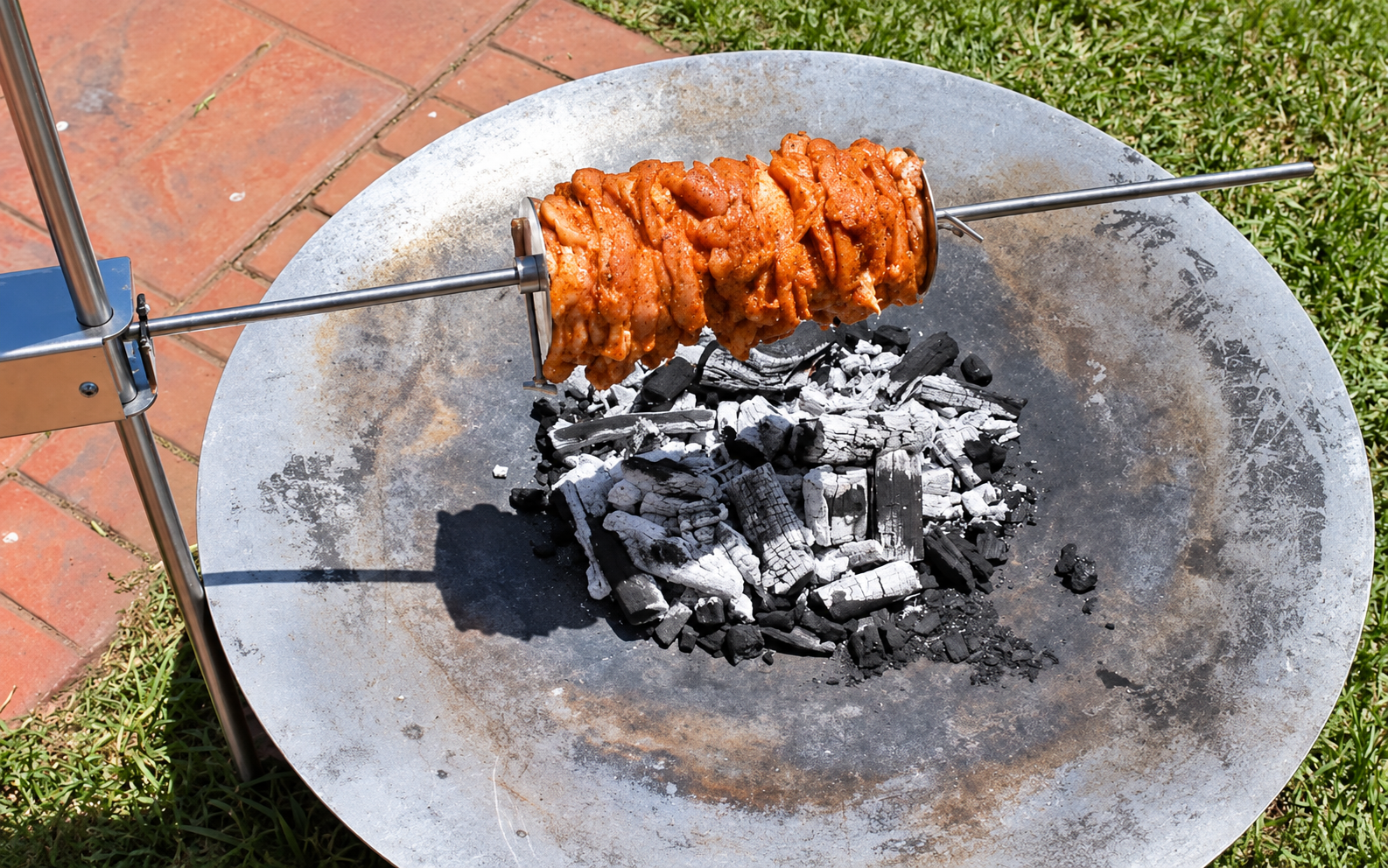This image shows the chicken gyros being cooked over charcoal. This image shows the chicken gyros being cooked over charcoal.