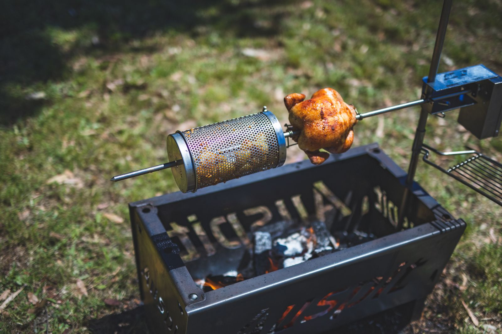 This image shows the Auspit Rotisserie cooking a whole chicken