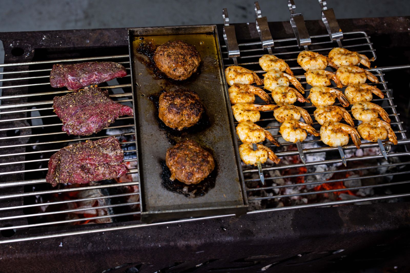 This image shows the Kangaroo steak beside the burger patties and prawns.