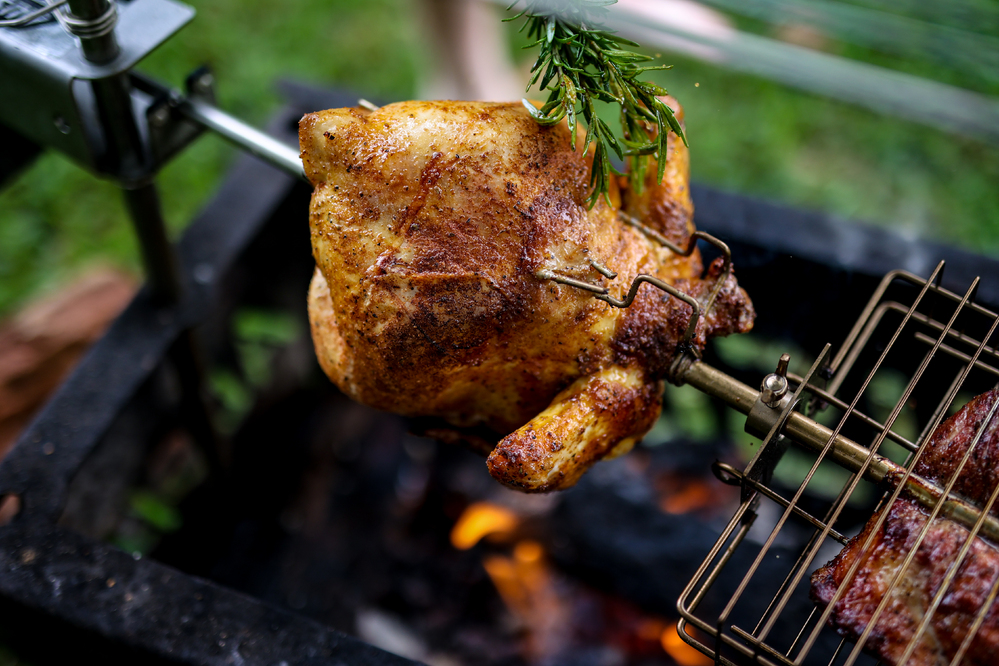 This image shows a whole chicken scured by squeezelock prongs on the Auspit.