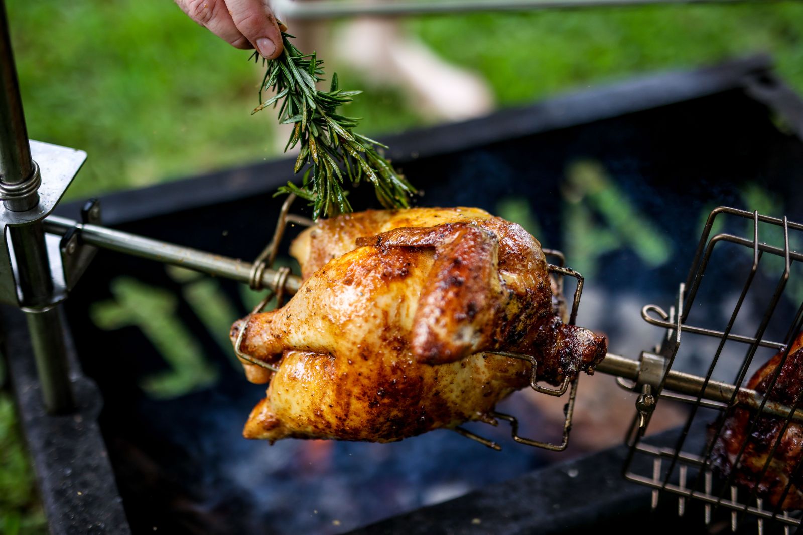 This image shows whole chicken being cooked in an Auspit.
