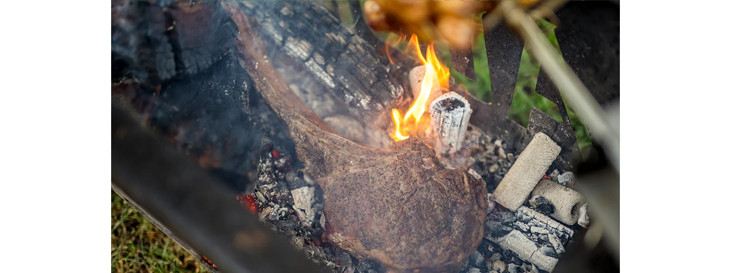 steak placed directly on coals