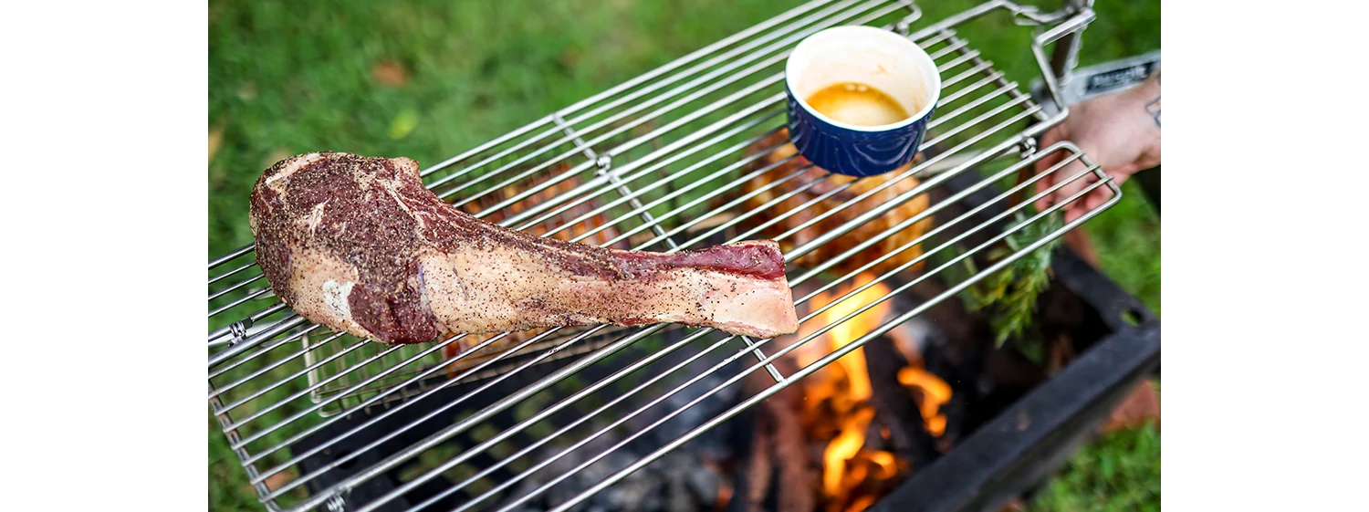 cooking steak over fire