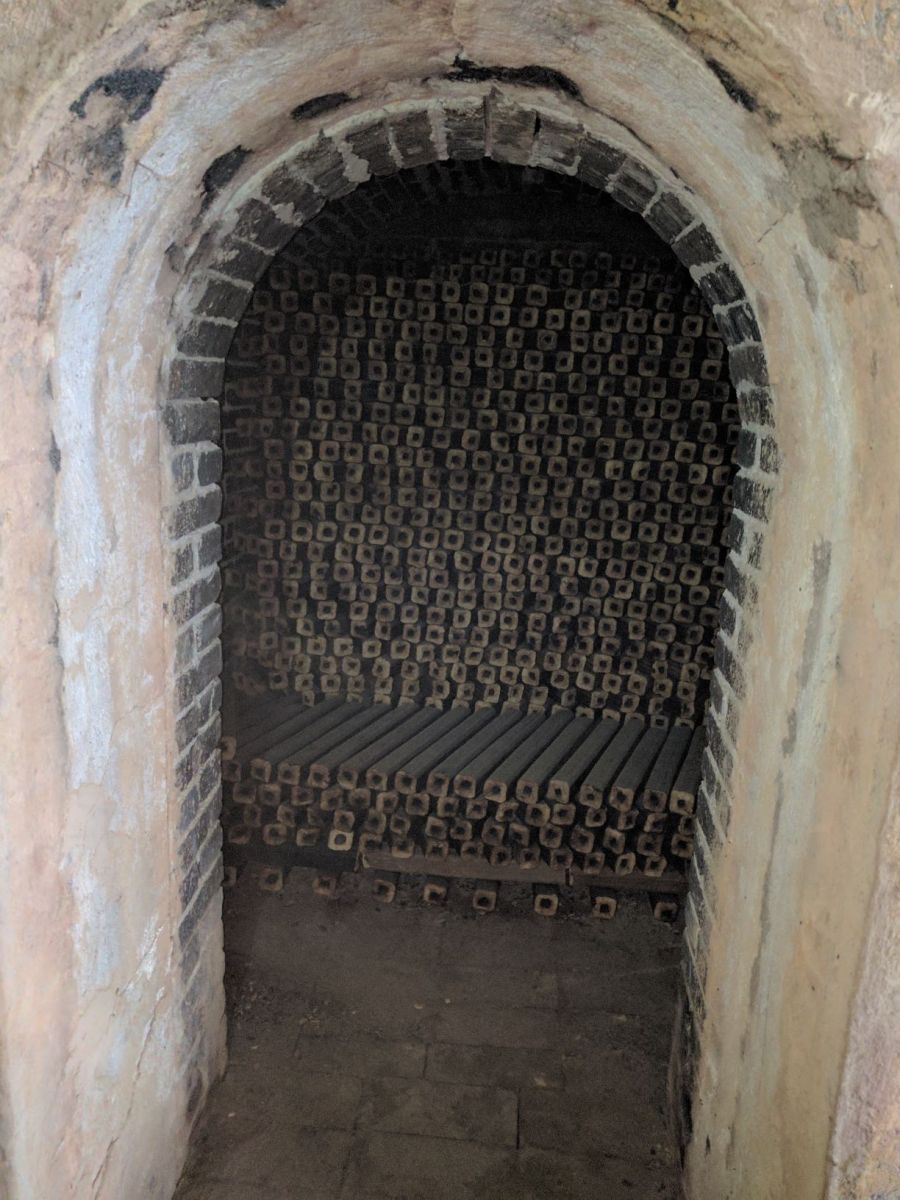 This image shows all the bamboo briquette logs stacked up in a kiln before they are burnt into charcoal