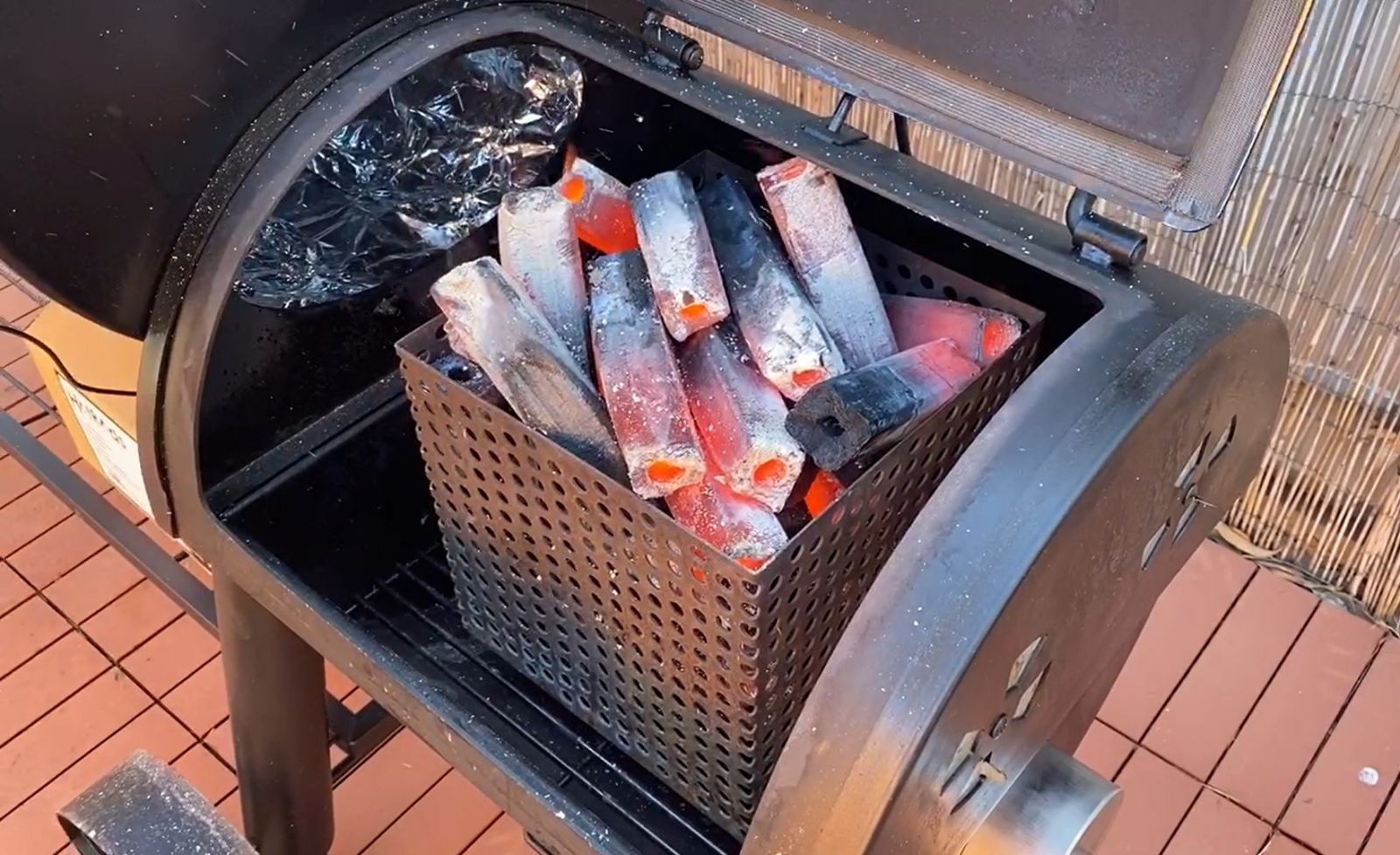 This image shows Japanese Grade charcoal briquettes being used in an offset smoker. The briquettes were placed in a Charcoal Basket