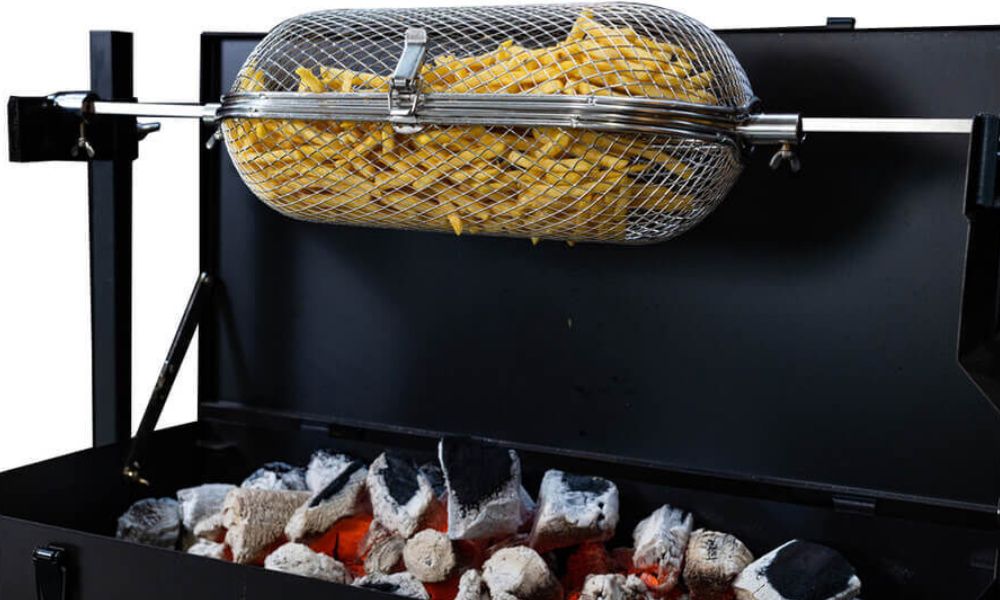 Flaming Coals round cage rotisserie basket cooking chips over charcoal on a spit